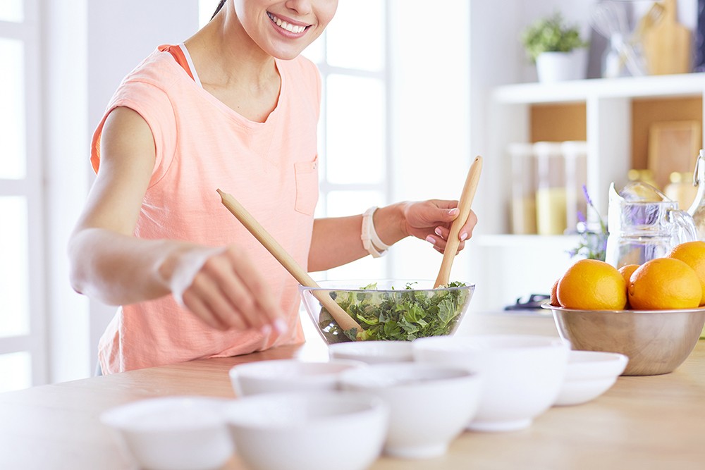Young woman cooking healthy meal