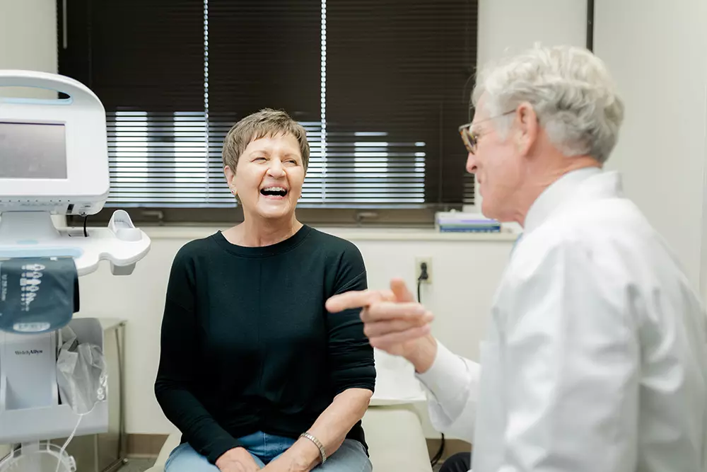 Dr Frame talking and laughing with a patient