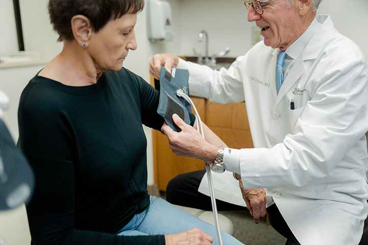 Dr. Frame taking a patient's blood pressure