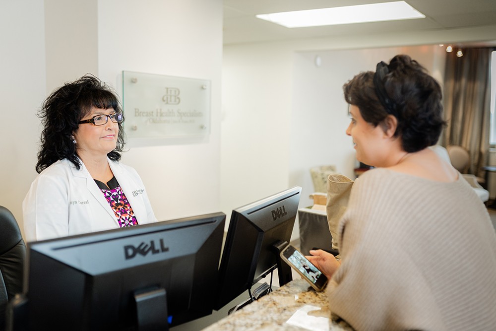 Administrative assistant greeting a patient