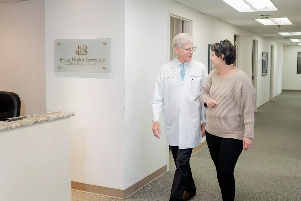 Dr. Frame walking through office with patient